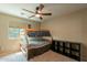 Bedroom featuring a wooden bunk bed, a window, a ceiling fan, and carpeted floors at 7169 S Dodane Ct, Gilbert, AZ 85298