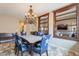 Dining room features a chandelier, floral chairs, and a view of the staircase at 7169 S Dodane Ct, Gilbert, AZ 85298