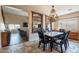 Open floor plan view of the dining room with chandelier and living room beyond at 7169 S Dodane Ct, Gilbert, AZ 85298