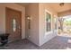 Front porch area featuring a decorative door and brick flooring at 7169 S Dodane Ct, Gilbert, AZ 85298