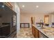 Bright kitchen featuring stainless steel appliances, a center island, and tiled flooring, providing ample space and style at 7169 S Dodane Ct, Gilbert, AZ 85298