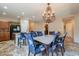 Open-concept kitchen and dining area featuring granite countertops and stainless steel appliances at 7169 S Dodane Ct, Gilbert, AZ 85298