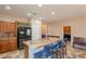 Kitchen island with granite countertop and bar seating, with black appliances and tile floor at 7169 S Dodane Ct, Gilbert, AZ 85298