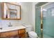 Standard bathroom featuring wood vanity, commode and shower with sliding glass door at 7424 E Cambridge Ave, Scottsdale, AZ 85257
