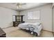 A bright bedroom with a ceiling fan and built in shelving, features a large window for natural light at 7424 E Cambridge Ave, Scottsdale, AZ 85257