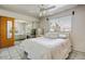 Bright bedroom featuring tile flooring, mirrored closet doors, and a ceiling fan at 7424 E Cambridge Ave, Scottsdale, AZ 85257
