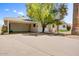 Charming single-story home featuring a large carport, basketball hoop, and lush landscaping at 7424 E Cambridge Ave, Scottsdale, AZ 85257