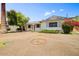 This single-story home has a large front yard and mature landscaping at 7424 E Cambridge Ave, Scottsdale, AZ 85257