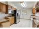 Bright kitchen with stainless steel refrigerator, wood cabinets, and white tile floor at 7424 E Cambridge Ave, Scottsdale, AZ 85257
