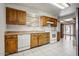 Traditional kitchen featuring wood cabinets, white appliances, and tile flooring at 7424 E Cambridge Ave, Scottsdale, AZ 85257