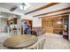 Open concept living room and kitchen with exposed beams and built-in cabinets at 7424 E Cambridge Ave, Scottsdale, AZ 85257