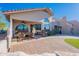 Desert property featuring a covered patio, backyard BBQ, and manicured yard with a brick paver patio at 8950 E Greenview Dr, Gold Canyon, AZ 85118