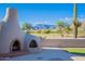 Backyard with an outdoor fireplace and view of a golf course at 8950 E Greenview Dr, Gold Canyon, AZ 85118