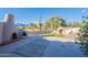 Wide backyard featuring an outdoor fireplace, seating, and a view of a golf course at 8950 E Greenview Dr, Gold Canyon, AZ 85118