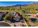 Expansive desert home with a tile roof, lush desert landscaping, and views of the nearby golf course at 8950 E Greenview Dr, Gold Canyon, AZ 85118