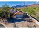 Desert home with a clay tile roof, two-car garage, and mountain views in a beautiful setting at 8950 E Greenview Dr, Gold Canyon, AZ 85118