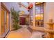 Beautiful front courtyard with arched windows, fountain, and lush greenery leading to the front door at 8950 E Greenview Dr, Gold Canyon, AZ 85118