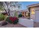 Well-maintained front yard with vibrant landscaping, stucco wall, and charming entry walkway at 8950 E Greenview Dr, Gold Canyon, AZ 85118