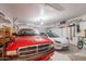 Spacious garage with two parked cars and storage shelves at 8950 E Greenview Dr, Gold Canyon, AZ 85118