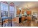 Open kitchen with hardwood floors, bar seating, and views to breakfast nook at 8950 E Greenview Dr, Gold Canyon, AZ 85118