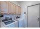 Laundry room featuring a washer, dryer, and upper cabinets at 8950 E Greenview Dr, Gold Canyon, AZ 85118