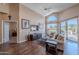 Bright living room features vaulted ceilings, wood floors, and large windows overlooking the lush landscape at 8950 E Greenview Dr, Gold Canyon, AZ 85118