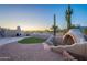 Desert property patio featuring brick pavers, a fireplace, outdoor kitchen, and stunning views at 8950 E Greenview Dr, Gold Canyon, AZ 85118