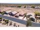 An aerial view of desert homes with clay tile roofs, wide streets, and desert vegetation at 9175 E Rainier Dr, Gold Canyon, AZ 85118