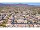 Wide aerial view of a beautiful desert community with mountain views and lush desert landscaping surrounding the homes at 9175 E Rainier Dr, Gold Canyon, AZ 85118