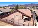 Backyard aerial view with a covered patio, low-maintenance landscape, and mountain views surrounded by community fencing at 9175 E Rainier Dr, Gold Canyon, AZ 85118