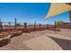 A desert backyard features gravel, patio blocks, brick walls, and a covered area at 9175 E Rainier Dr, Gold Canyon, AZ 85118