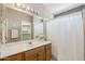 Bathroom features wooden vanity, large mirror, and shower with white curtain at 9175 E Rainier Dr, Gold Canyon, AZ 85118