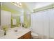Well-lit bathroom with bright green walls, white fixtures, and a functional layout for everyday use at 9175 E Rainier Dr, Gold Canyon, AZ 85118