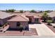 Charming single-story home featuring a beautiful tile roof, neutral stucco and a spacious driveway in a well maintained community at 9175 E Rainier Dr, Gold Canyon, AZ 85118