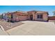 Charming single-Gathering home featuring a well-maintained front yard and wide driveway leading to a two-car garage at 9175 E Rainier Dr, Gold Canyon, AZ 85118