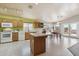 Bright kitchen featuring oak cabinets, white appliances, and a spacious island with room for seating at 9175 E Rainier Dr, Gold Canyon, AZ 85118