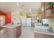 Open kitchen offers an island, natural light, and storage space at 9175 E Rainier Dr, Gold Canyon, AZ 85118