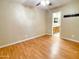 Bright bedroom with hardwood floors, ceiling fan, and adjacent bathroom at 924 S Hacienda Dr # C, Tempe, AZ 85281