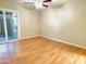Bedroom with ceiling fan, wood floors, and sliding door to backyard at 924 S Hacienda Dr # C, Tempe, AZ 85281
