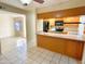 View of kitchen with black appliances, tile backsplash, and light wood cabinets at 924 S Hacienda Dr # C, Tempe, AZ 85281