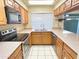 Well-lit kitchen featuring tile floors, stainless steel appliances, and neutral countertops at 924 S Hacienda Dr # C, Tempe, AZ 85281