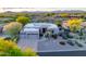 An aerial view of a home with desert landscaping and a three car attached garage at 9322 E Hidden Green Dr, Scottsdale, AZ 85262