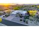 Aerial view of a desert home with low maintenance landscaping and attached three car garage at 9322 E Hidden Green Dr, Scottsdale, AZ 85262