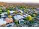 Stunning aerial view of luxury homes with private pools nestled in a lush desert landscape and mountain backdrop at 9322 E Hidden Green Dr, Scottsdale, AZ 85262