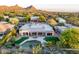 Stunning aerial view of the backyard featuring a pool, patio, and lush landscaping at 9322 E Hidden Green Dr, Scottsdale, AZ 85262
