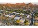 Expansive aerial view showcasing luxury homes in a desert setting with mountain views and beautiful community landscaping at 9322 E Hidden Green Dr, Scottsdale, AZ 85262