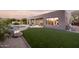 Spacious backyard featuring a pool, patio, and lush artificial turf, creating a perfect outdoor retreat at 9322 E Hidden Green Dr, Scottsdale, AZ 85262