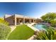 Stunning backyard with a pool, artificial turf, and mature landscaping offering privacy at 9322 E Hidden Green Dr, Scottsdale, AZ 85262