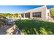 Serene backyard featuring artificial turf, outdoor seating, and a sparkling pool at 9322 E Hidden Green Dr, Scottsdale, AZ 85262
