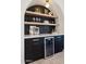 Stylish home bar featuring dark cabinetry, marble countertop, and a wine refrigerator at 9322 E Hidden Green Dr, Scottsdale, AZ 85262